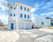 Modern coastal piling home on Navarre Beach by Acorn Fine Homes