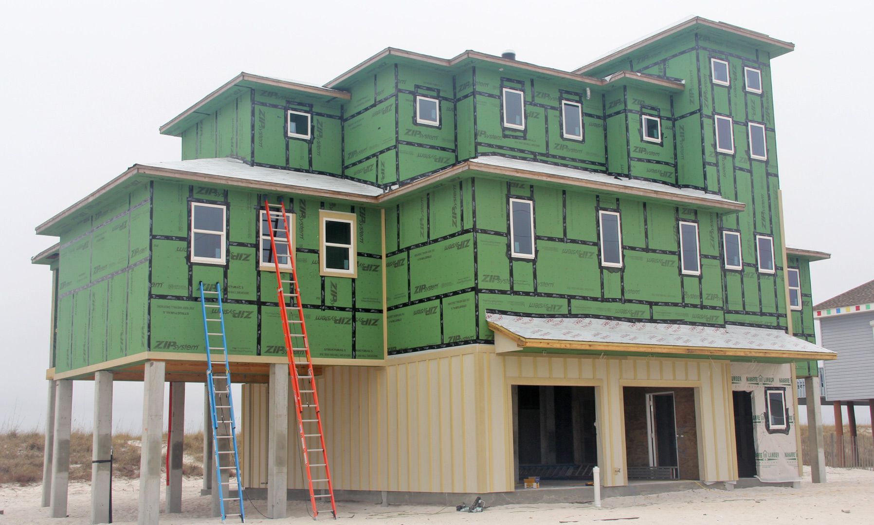 Burchard modern coastal style piling home on Navarre by Acorn Fine Homes