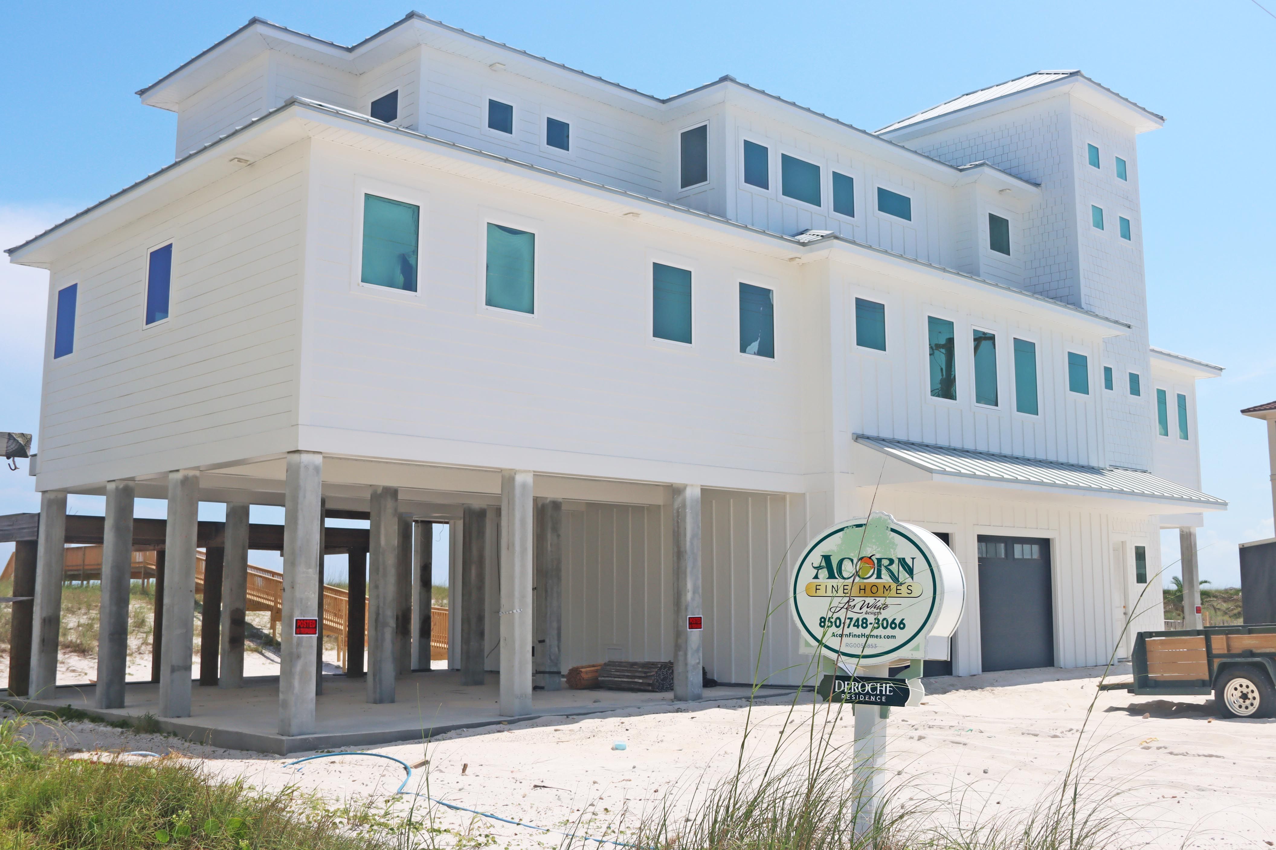 Modern coastal piling home in Navarre by Acorn Fine Homes