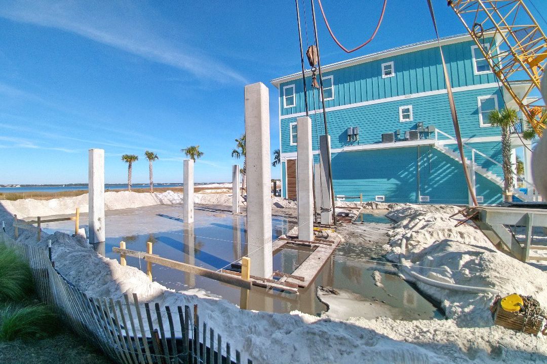 Modern coastal piling home on Navarre Beach by Acorn Fine Homes