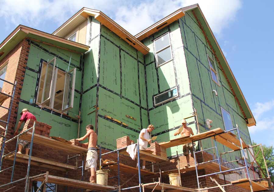 Laying brick up three stories on the Spear job