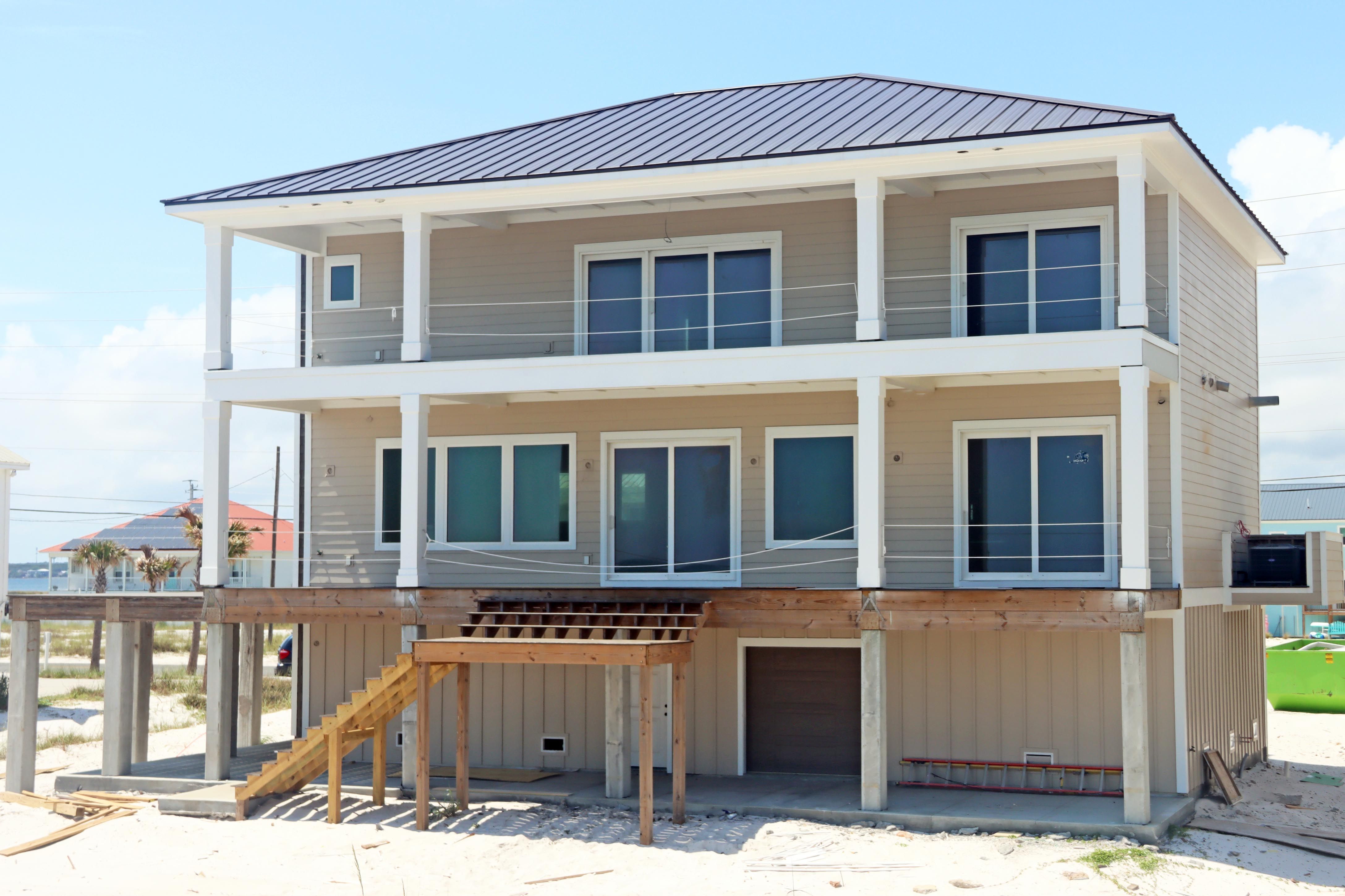 Modern coastal piling home in Navarre by Acorn Fine Homes