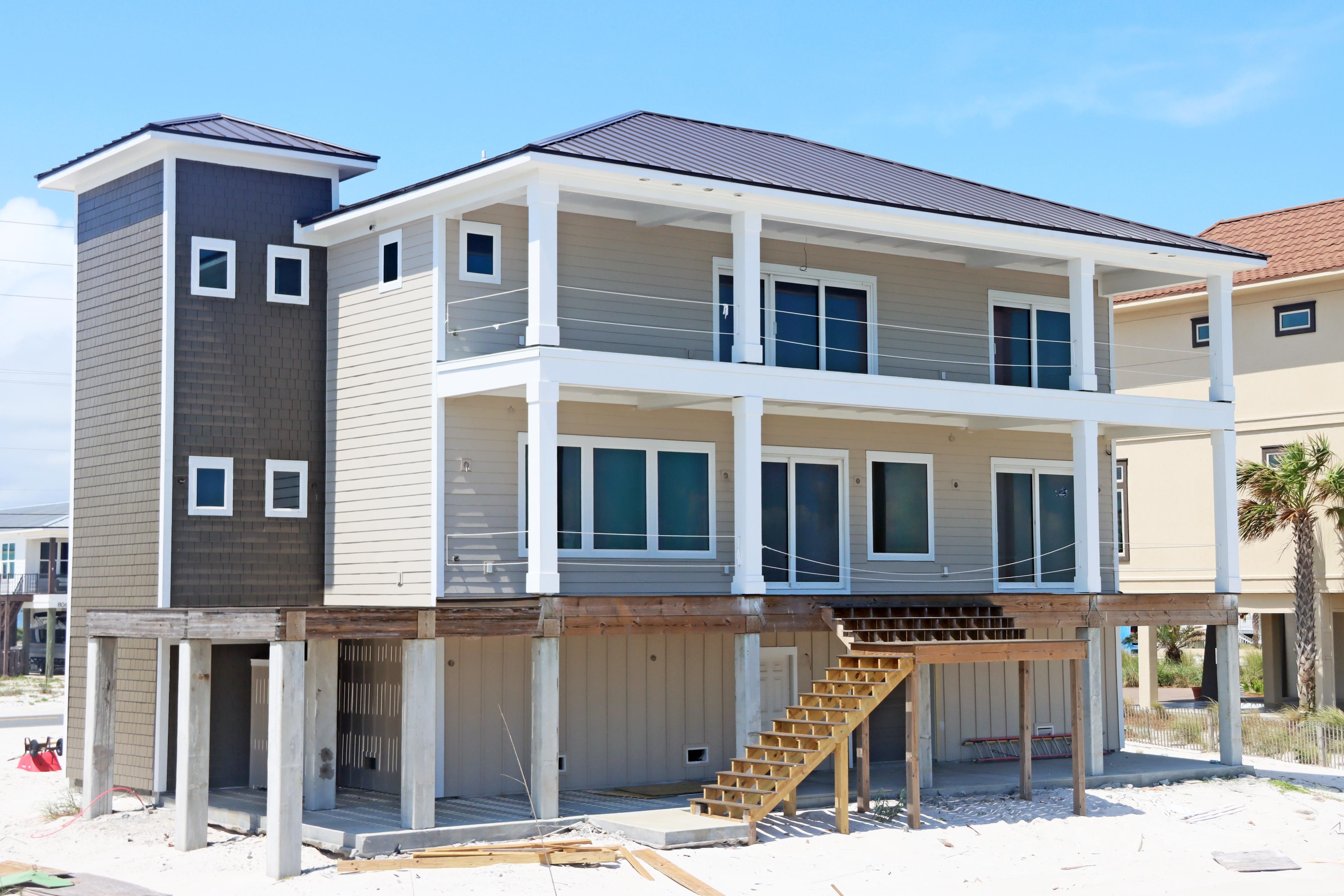 Modern coastal piling home in Navarre by Acorn Fine Homes