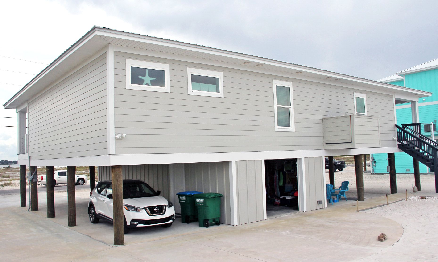 Moreland modern piling home on Navarre Beach by Acorn Fine Homes