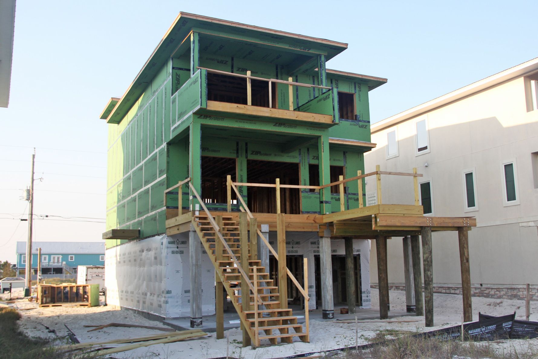 Davis modern coastal piling home on Navarre Beach by Acorn Fine Homes