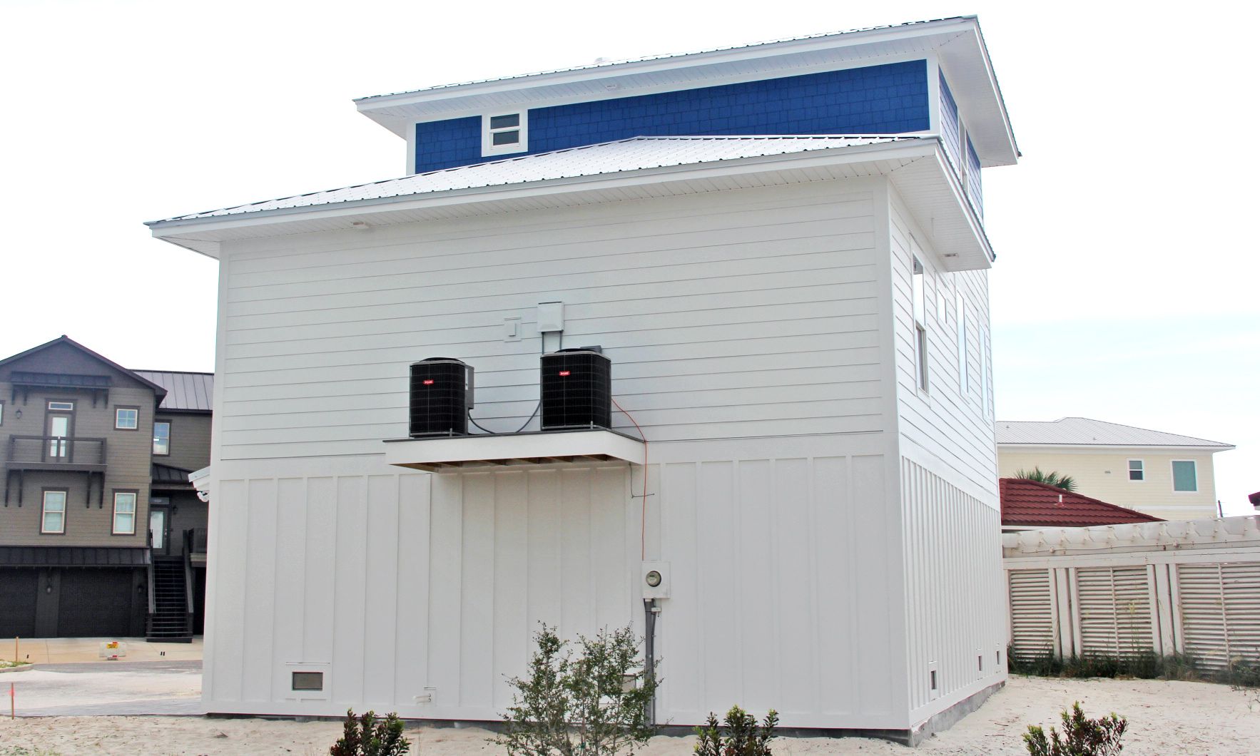 Slone modern coastal piling home on Navarre Beach by Acorn Fine Homes