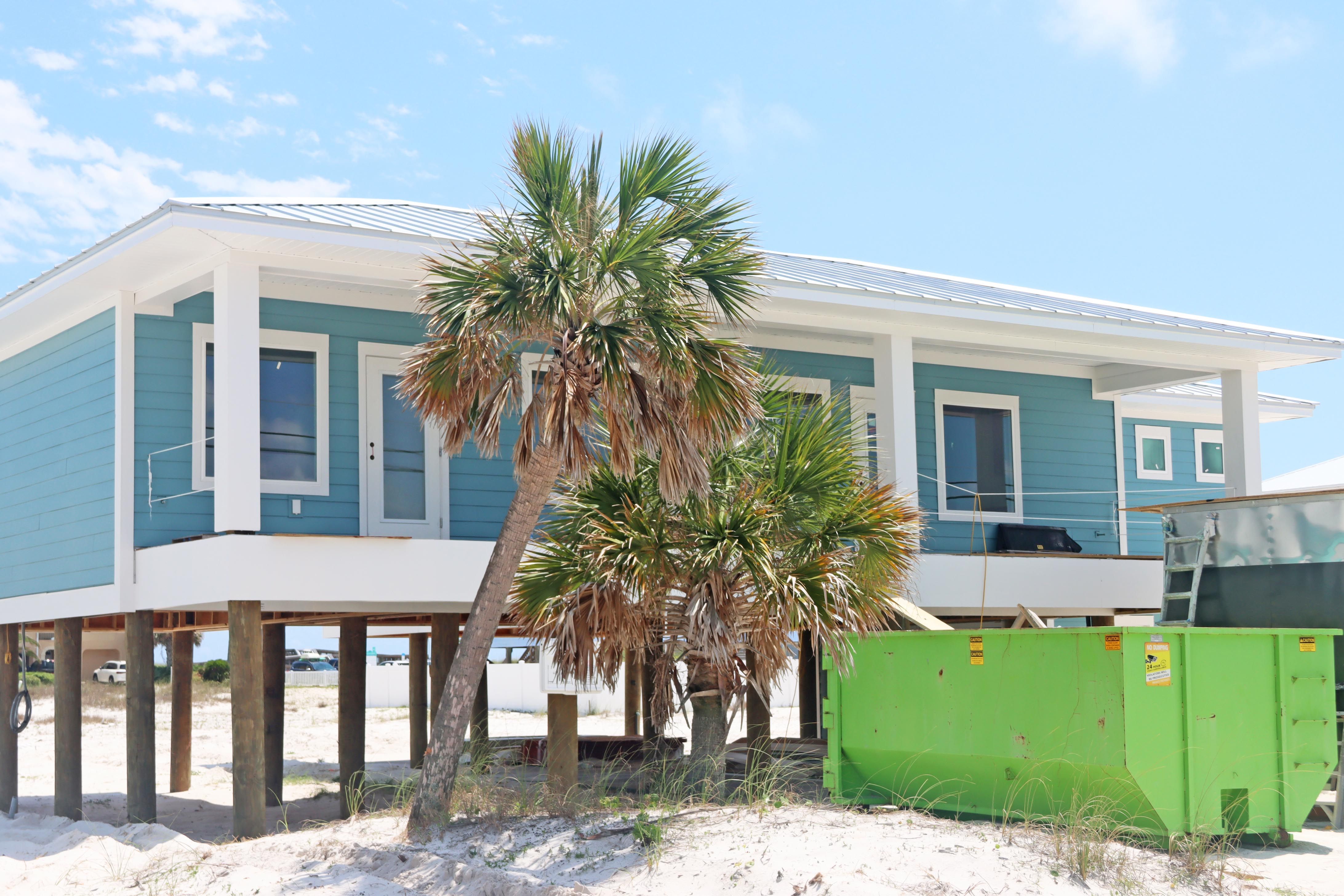 Modern coastal piling home in Navarre by Acorn Fine Homes