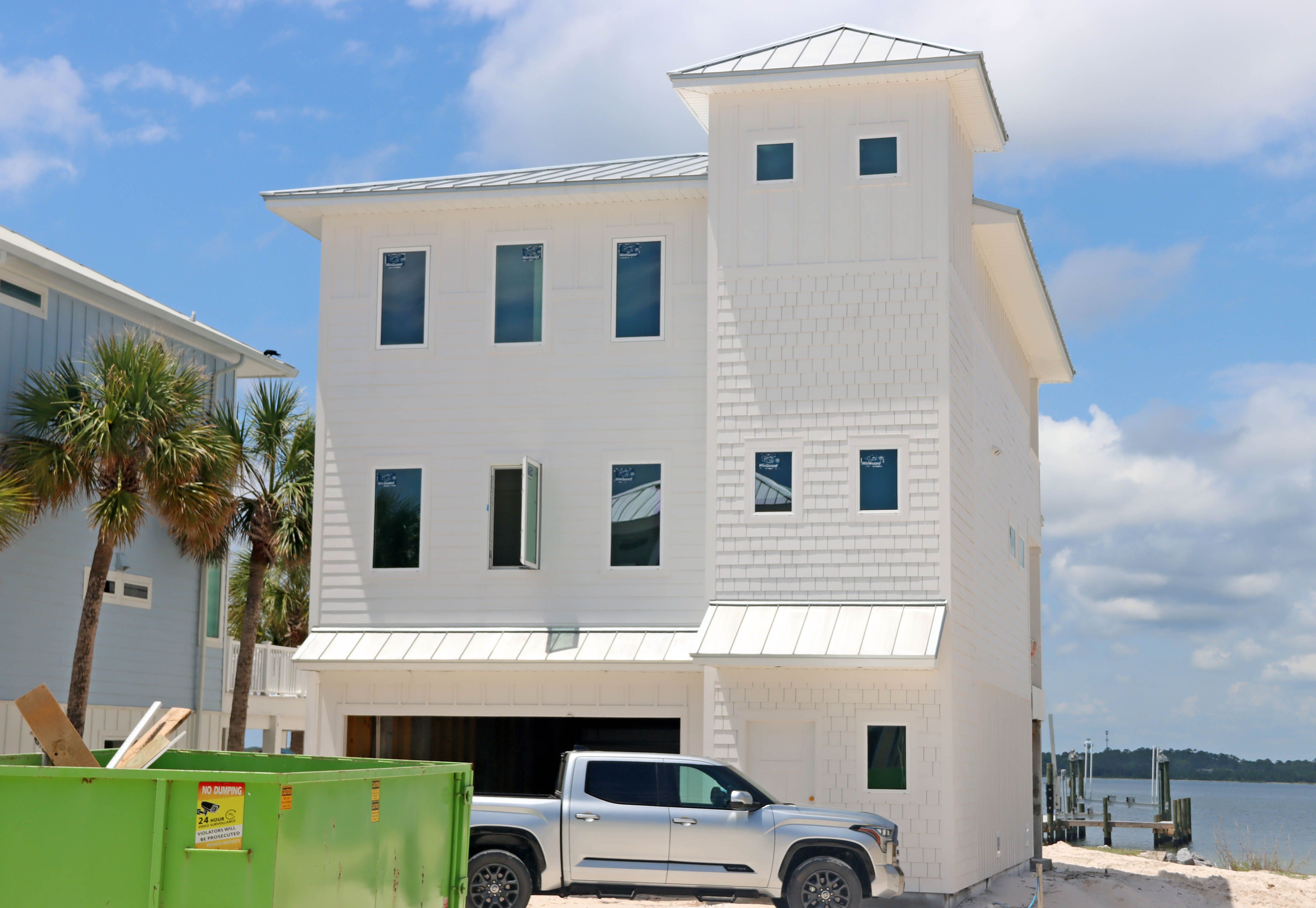 Modern coastal piling home in Navarre by Acorn Fine Homes