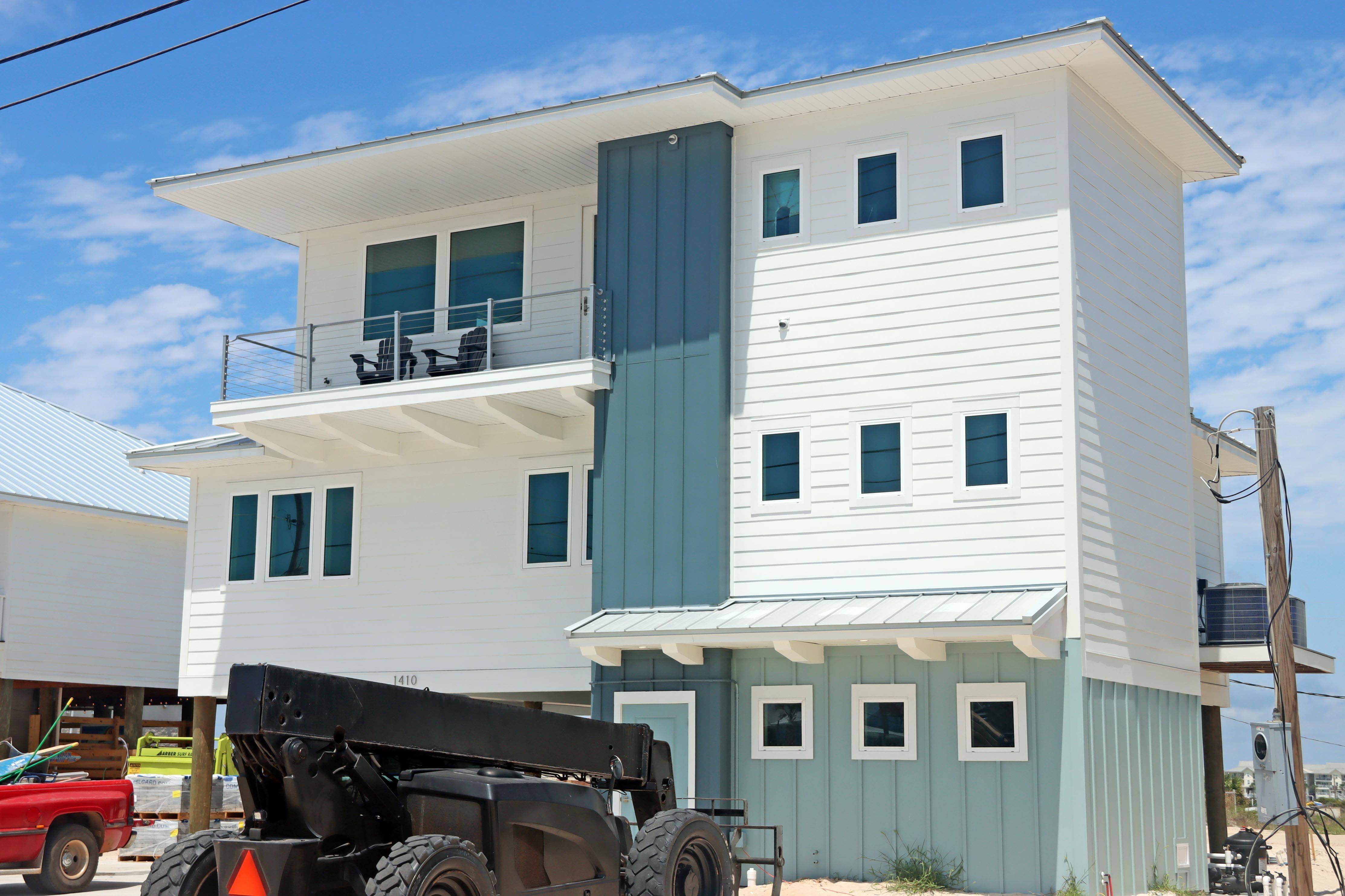 Modern coastal piling home in Navarre by Acorn Fine Homes