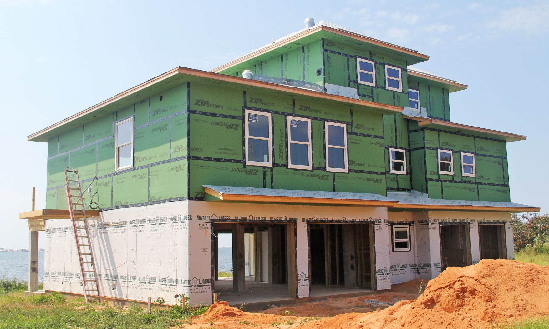 Modern coastal piling home in Navarre by Acorn Fine Homes