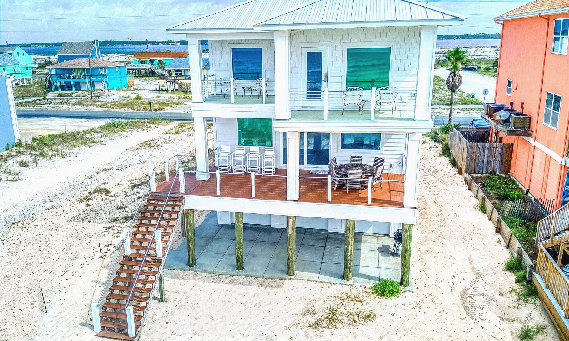 Modern coastal piling home on Navarre Beach by Acorn Fine Homes