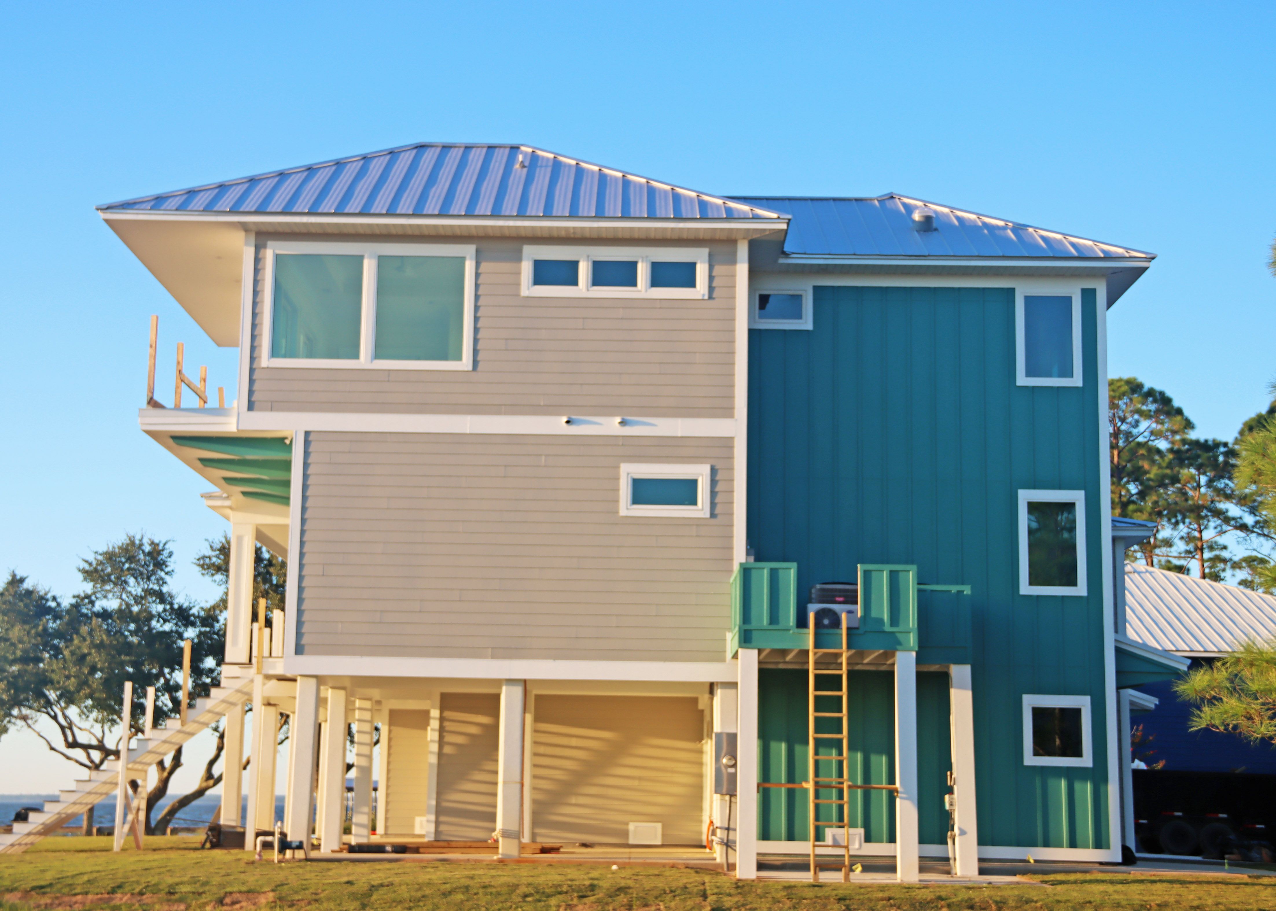 Modern piling home in Navarre, Gulf Breeze, Milton by Acorn Fine Homes