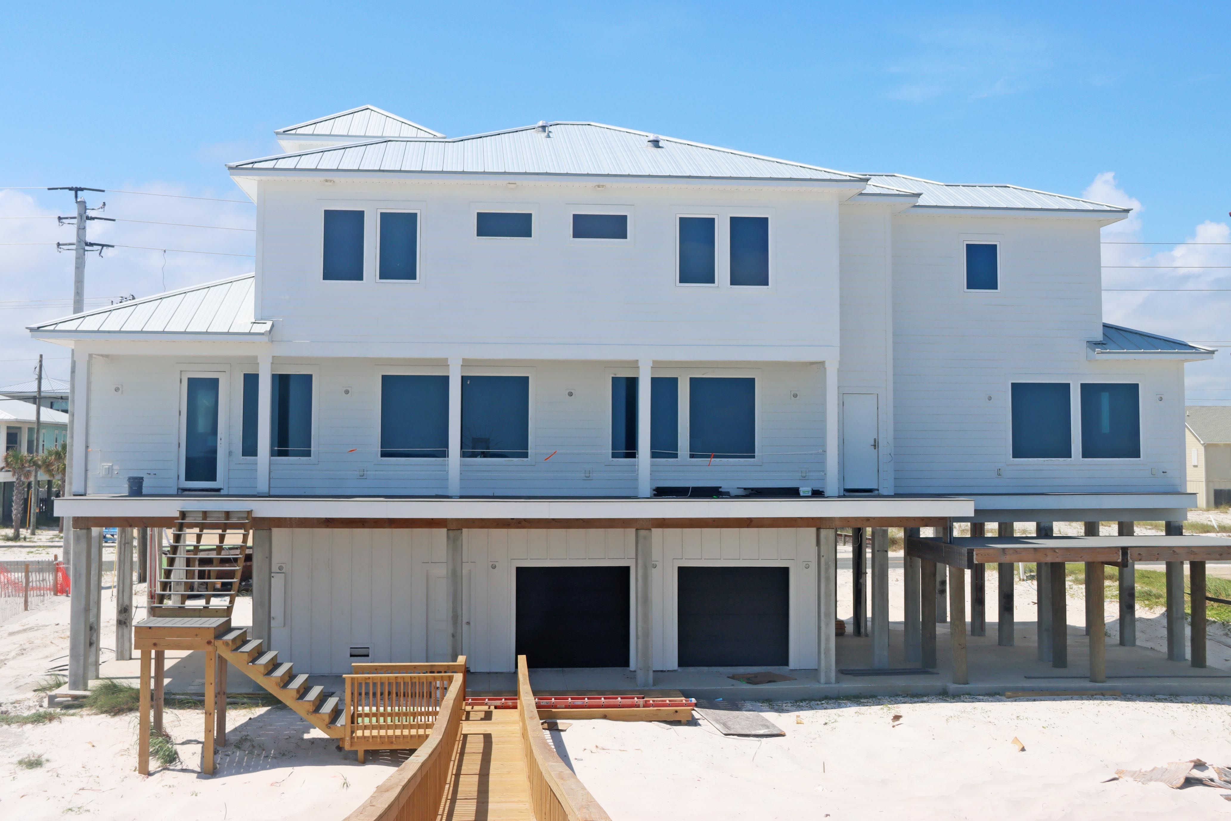 Modern coastal piling home in Navarre by Acorn Fine Homes