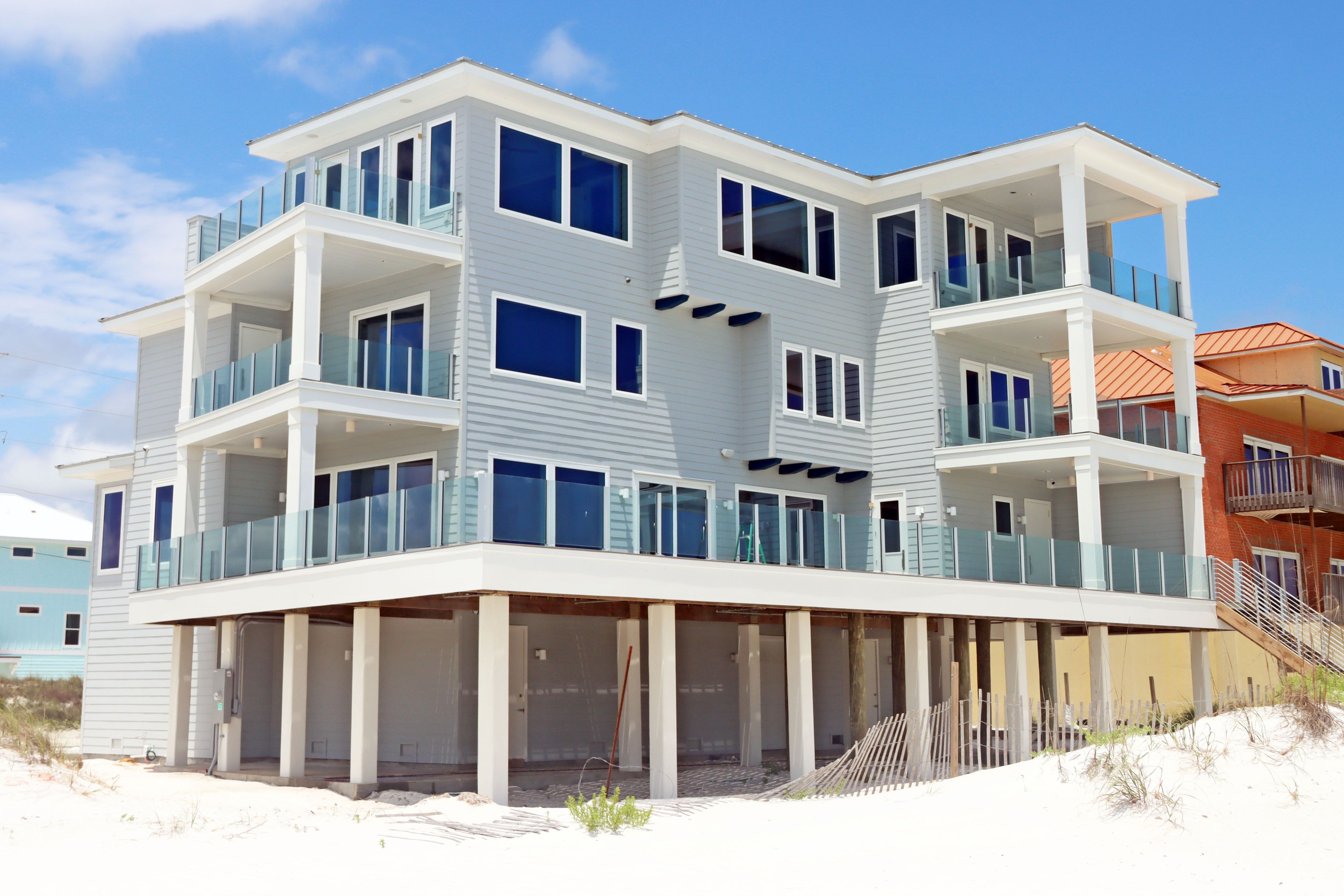 Modern coastal piling home in Navarre by Acorn Fine Homes