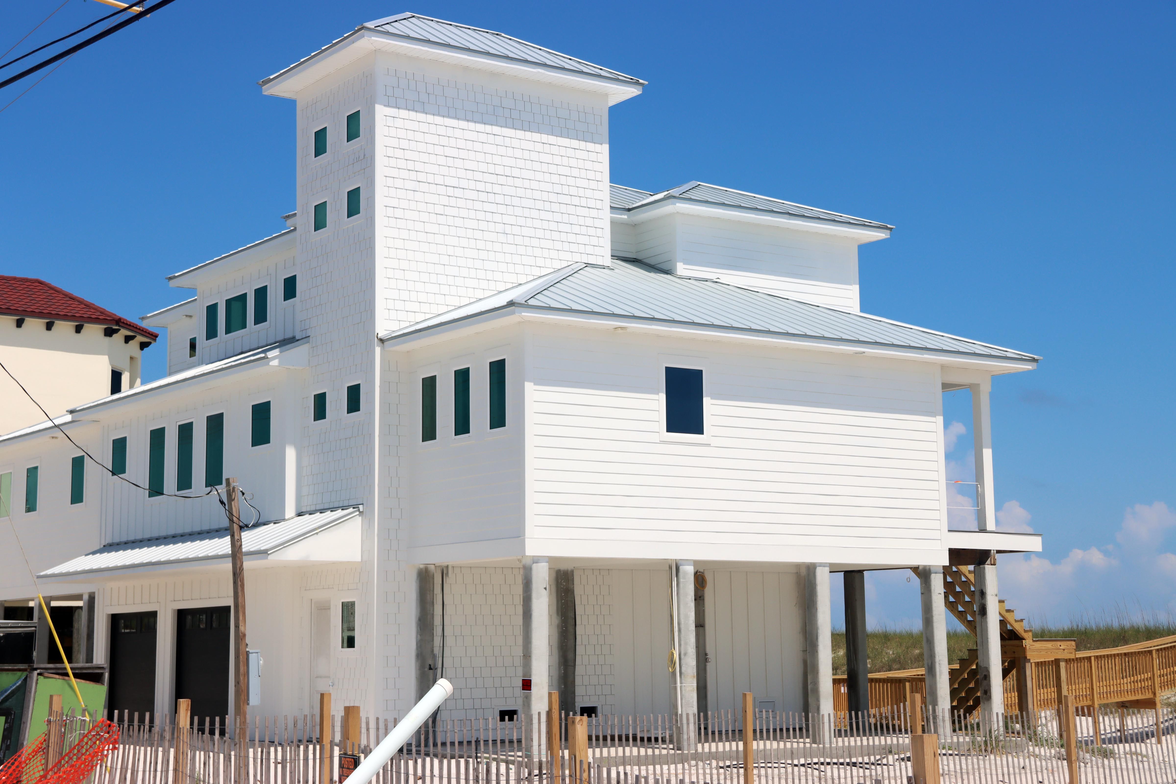 Modern coastal piling home in Navarre by Acorn Fine Homes