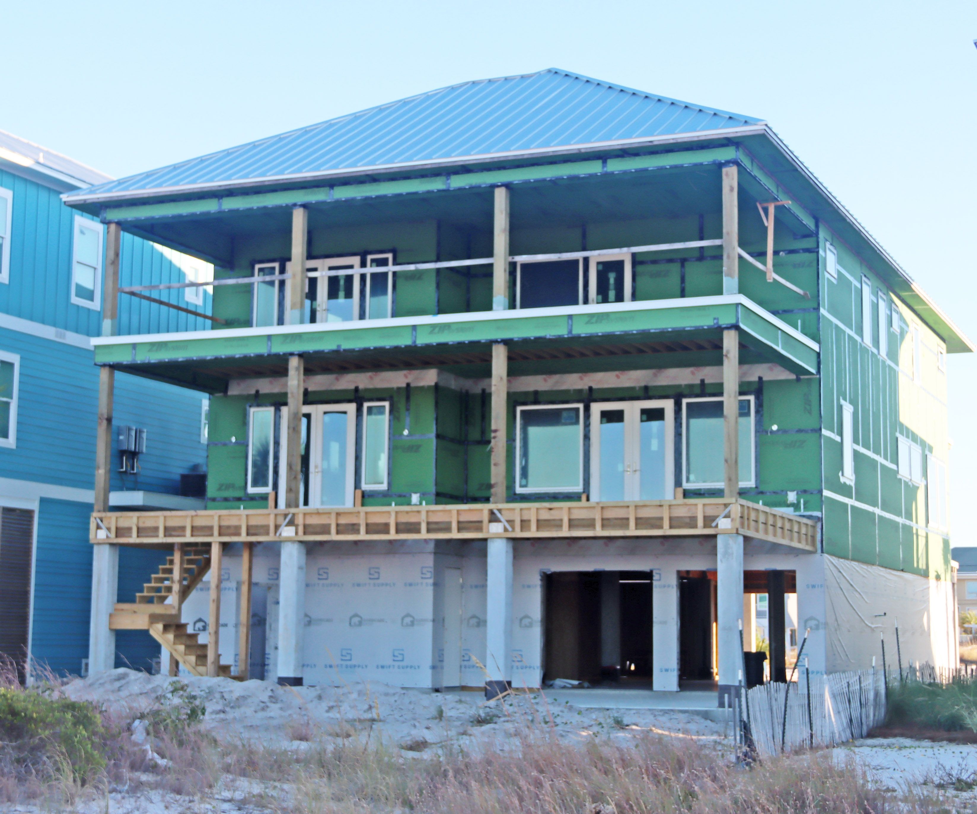 Modern coastal piling home in Navarre by Acorn Fine Homes