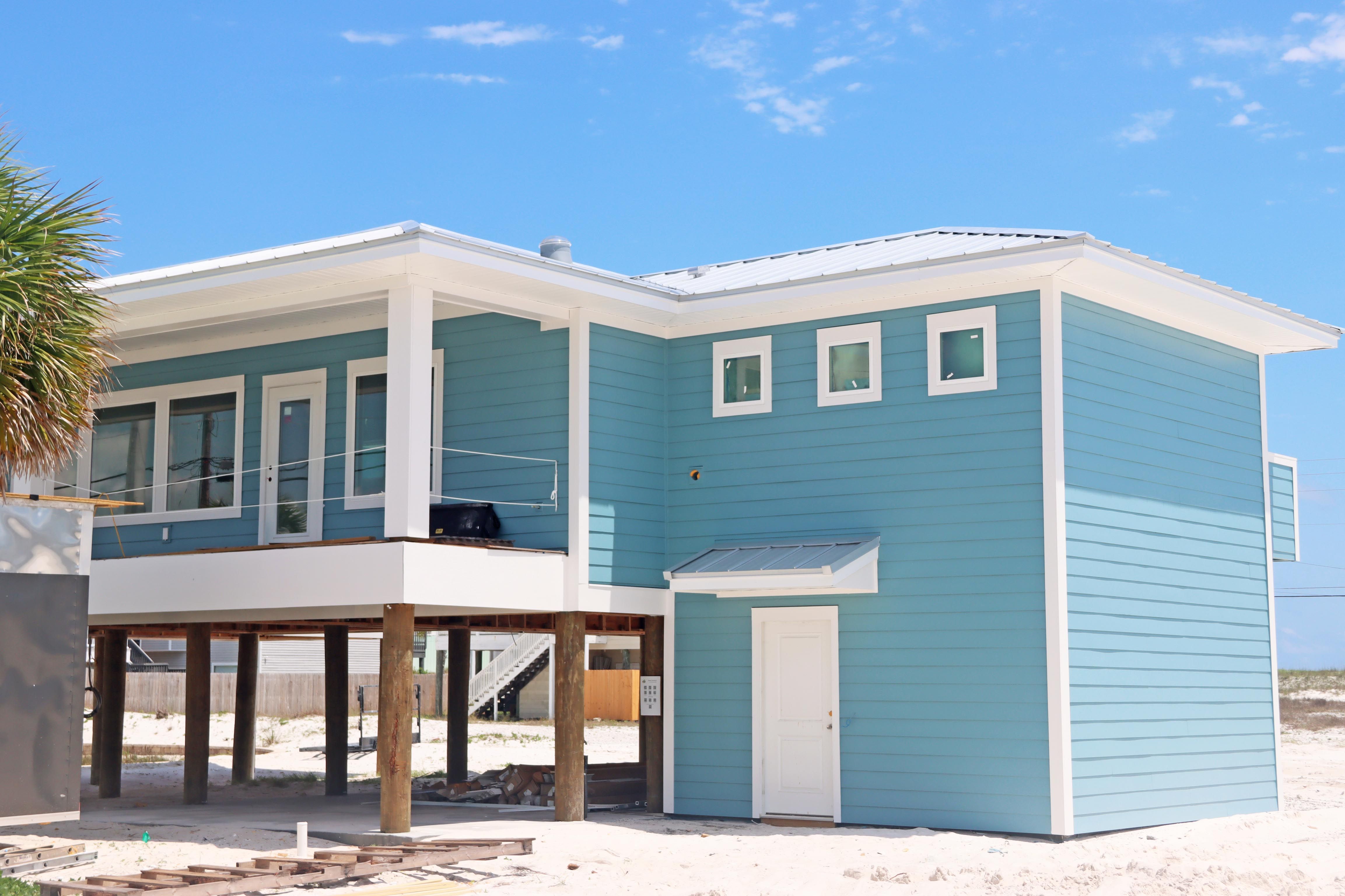 Modern coastal piling home in Navarre by Acorn Fine Homes