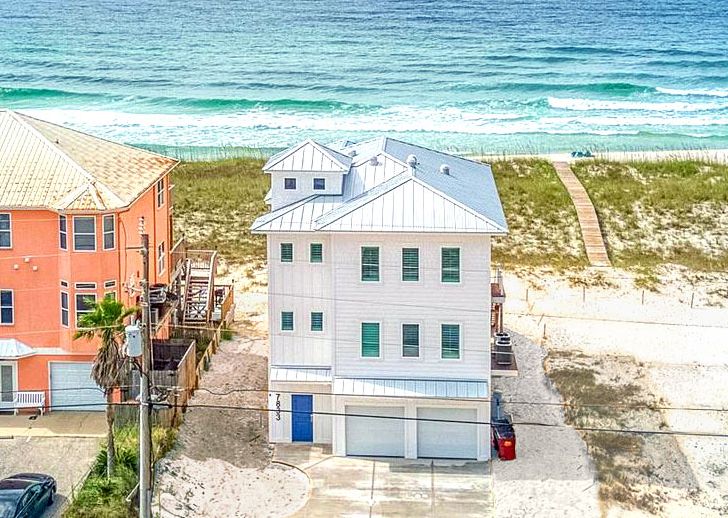 Modern coastal piling home on Navarre Beach by Acorn Fine Homes