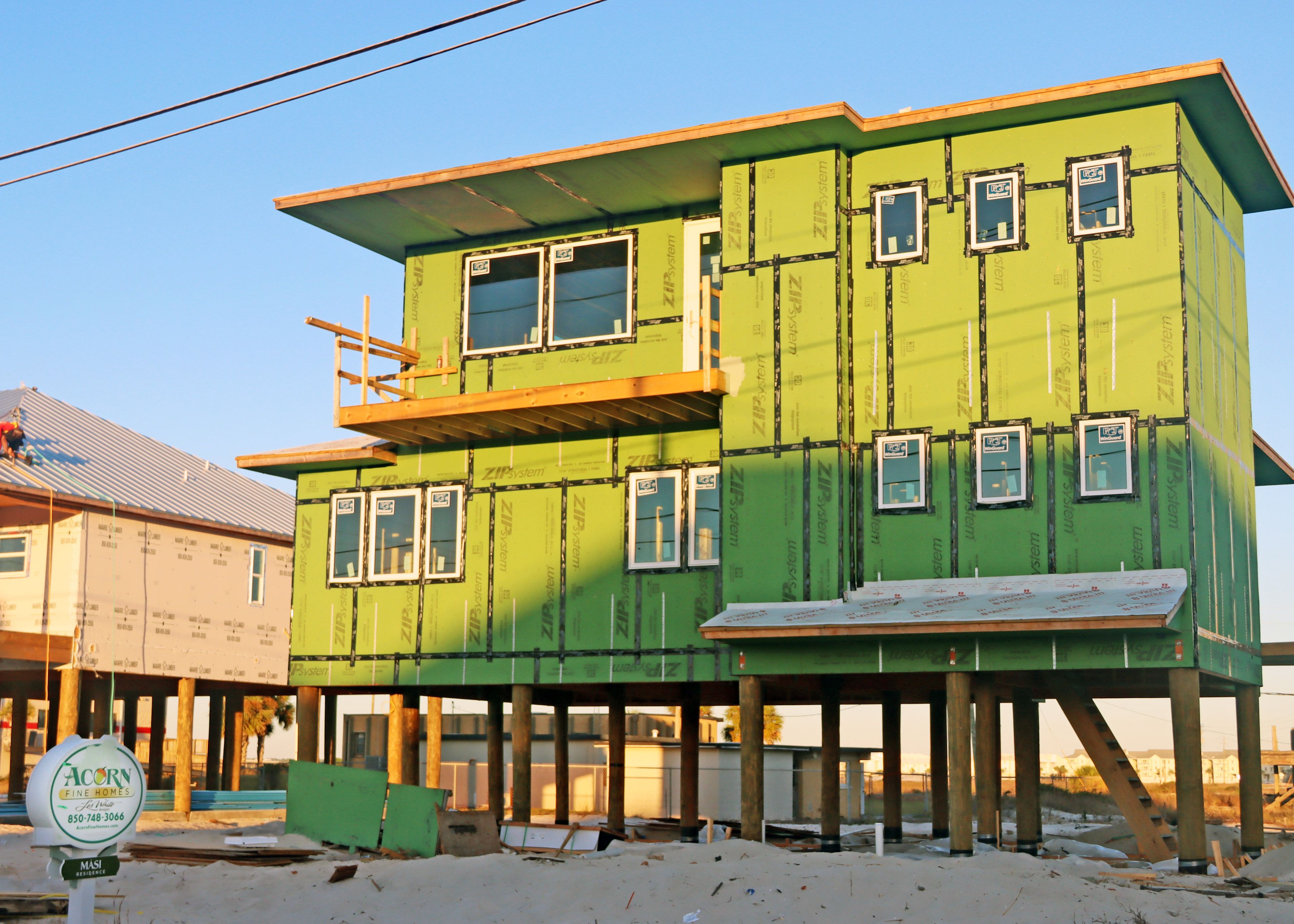 Modern coastal piling vacation rental home in Navarre by Acorn Fine Homes