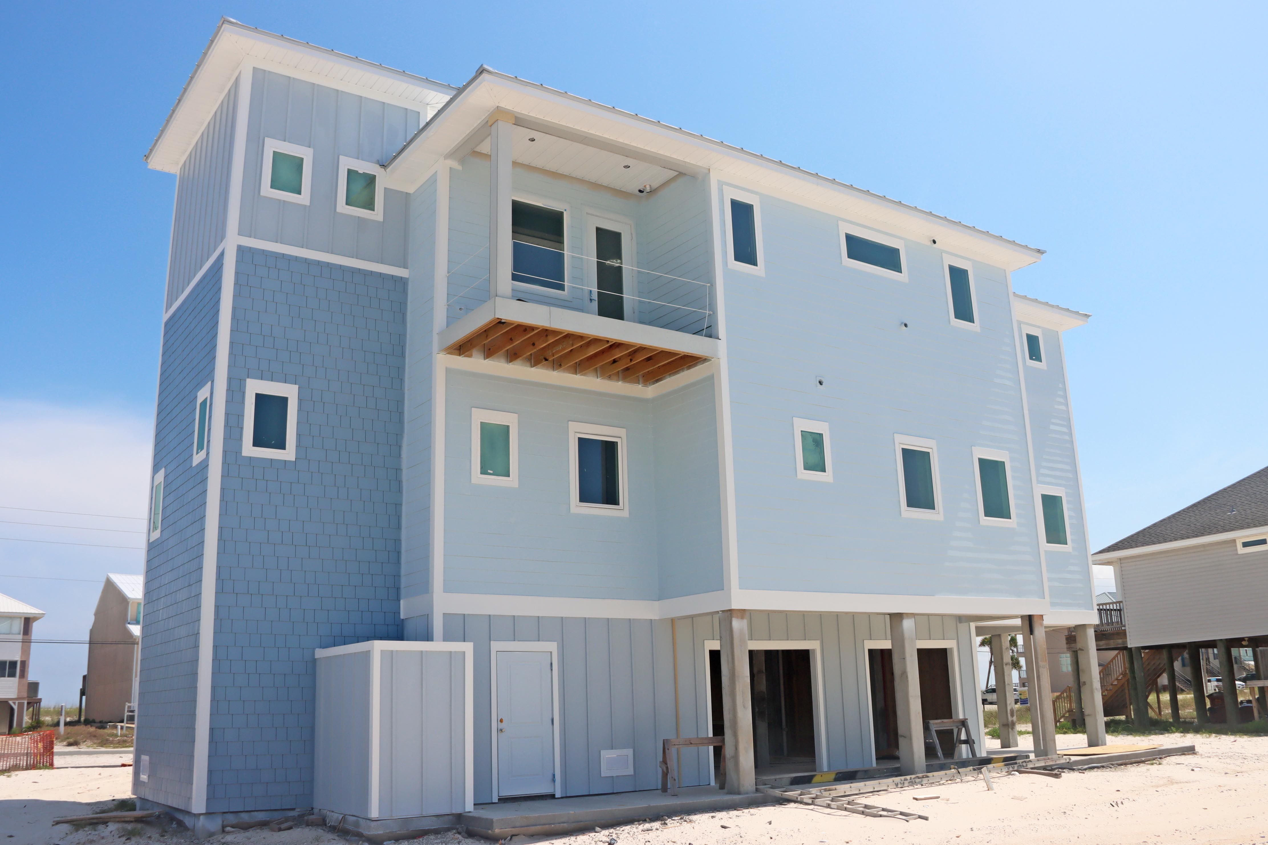 Modern coastal piling home in Navarre by Acorn Fine Homes